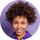 Smiling woman with curly hair against a purple background