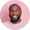 Smiling man with a beard against a pink background