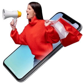Woman in a red sweater using a megaphone while holding shopping bags